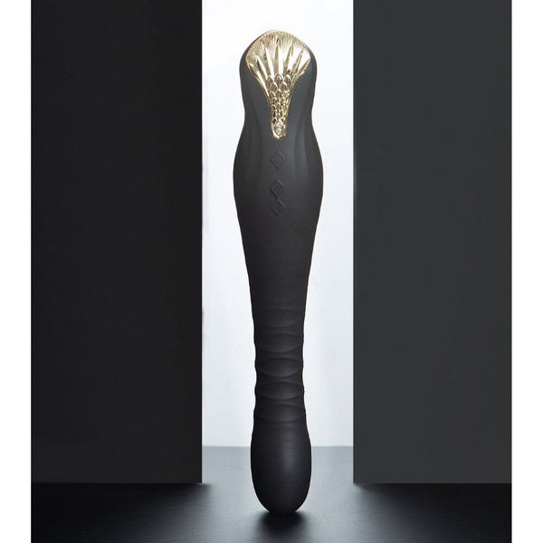 Stimulateur noir en silicone texturé avec finition dorée, présenté à la verticale sur fond sombre, proposé par Brigade Mondaine Paris.