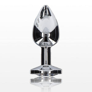 Plug anal en métal argenté poli effet miroir, à la forme lisse et effilée avec base plate assurant stabilité, présenté sur fond blanc dans une esthétique épurée.