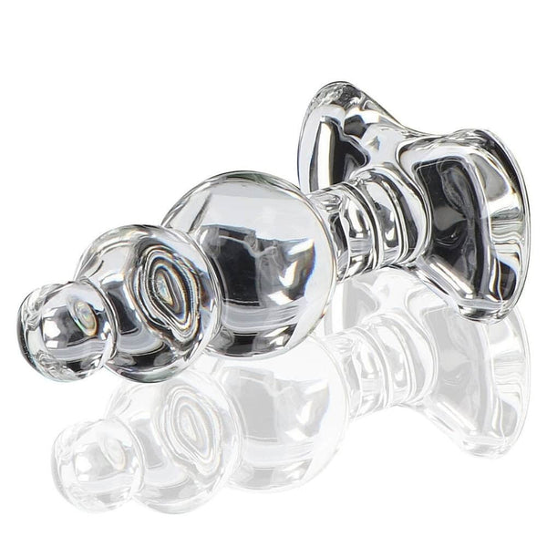 Plug anal en verre transparent à forme facettée avec base évasée, présenté sur fond clair, finition brillante, sélection Brigade Mondaine Paris.