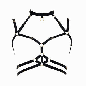 Harnais bondage Moon FLASH en sangles noires avec anneaux dorés, vue à plat sur fond blanc, design graphique et ajustable - Brigade Mondaine Paris