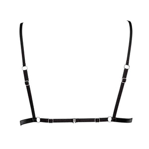 Bralette Iggy Collection Caravasar de la marque Gonzalez. Cette bralette est de forme triangle et de couleur noir. Deux petits anneaux de couleur argent sont placé au bout de bonnets au niveau du plexus solaire et tiennent deux petits élastiques décoratifs. Les bonnets sont en tulles et les bretelles fines. La bralette s’attache au dos à l’aide d’un simple crochet.