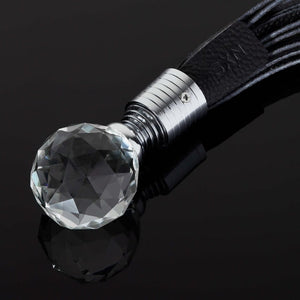 Détail sur le Manche du Pakshot d'un Martinet en Cuir Noir avec Manche en Verre et Métal Argent