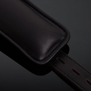 Menottes en cuir embossé serpent rouge avec finitions dorées et intérieur en cuir de veau noir, offrant confort et maintien avec un design visuellement saisissant.