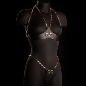 String ARIA IINFYNII en cuir noir avec chaînes dorées et symbole infini, pièce minimaliste et graphique, sélection Brigade Mondaine Paris