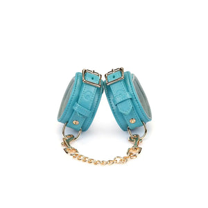 Menottes Agneau Bleu LIEBE SEELE en cuir bleu doublé agneau clair avec fermeture réglable, anneaux métalliques et chaîne dorée, photographiées sur fond blanc