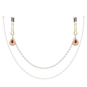 Pinces à tétons chaînes perles de la marque Liebe Seele, composées de pinces dorées reliées par une chaîne de perles blanches avec ornements sertis, présentées sur fond clair dans l’univers Brigade Mondaine Paris.