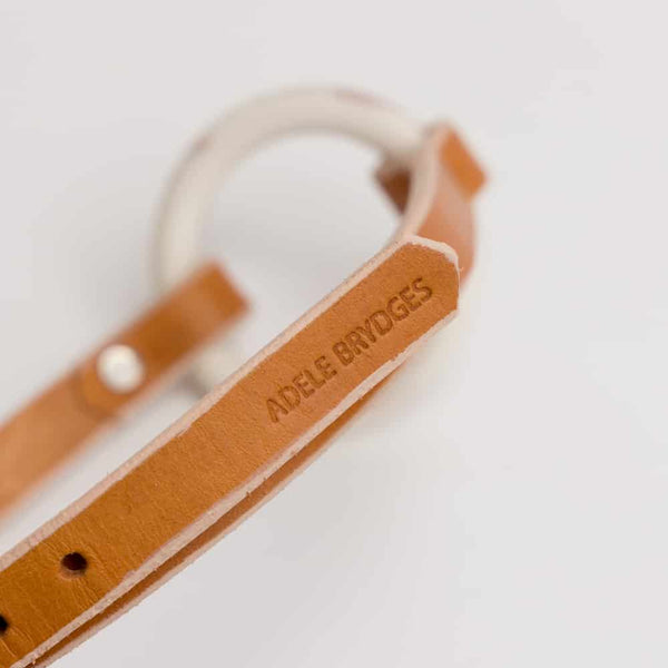 Collier OYA orangé mini balle au centre du collier fait en porcelaine rose et blanc de adules brydges chez brigade mondaine.