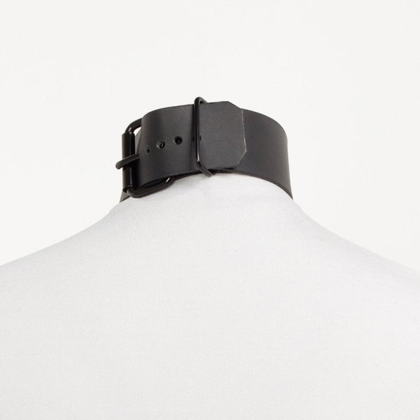Modèle portant le choker Divine Perlensau en cuir noir avec large anneau métallique suspendu, proposé par Brigade Mondaine Paris.