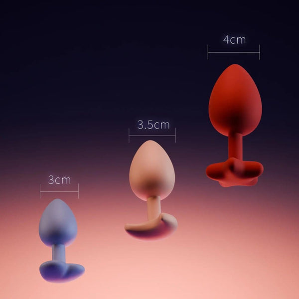 Accessoires anaux UPKO en silicone de différentes tailles 3 cm 3.5 cm et 4 cm présentés sur fond dégradé Brigade Mondaine Paris