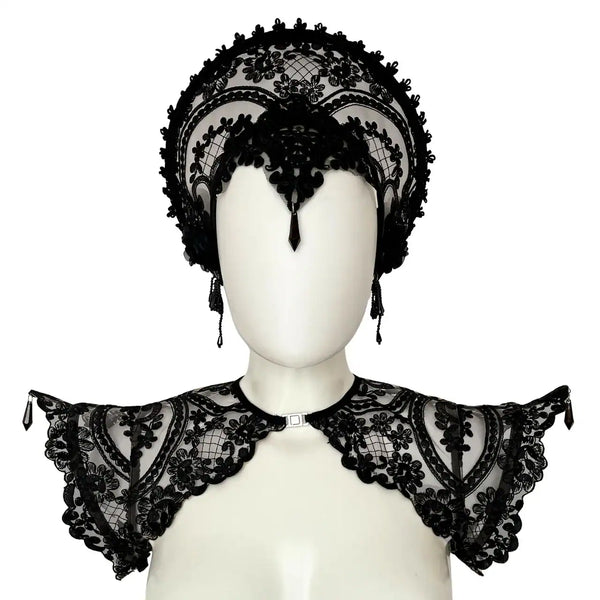 Handmade in Italy with custom floral embroidery on black mesh, this sculptural epaulette is reinforced with internal metal boning along the shoulder line to maintain its dramatic, elevated silhouette. Adjustable elastic bands positioned under the arms ensure comfort and stability while preserving structure. Front opening with metal clasp for a clean neckline and easy wear. Lightweight yet statement-making — a refined construction that balances delicacy and strength. Available in multiple sizes. Please refer