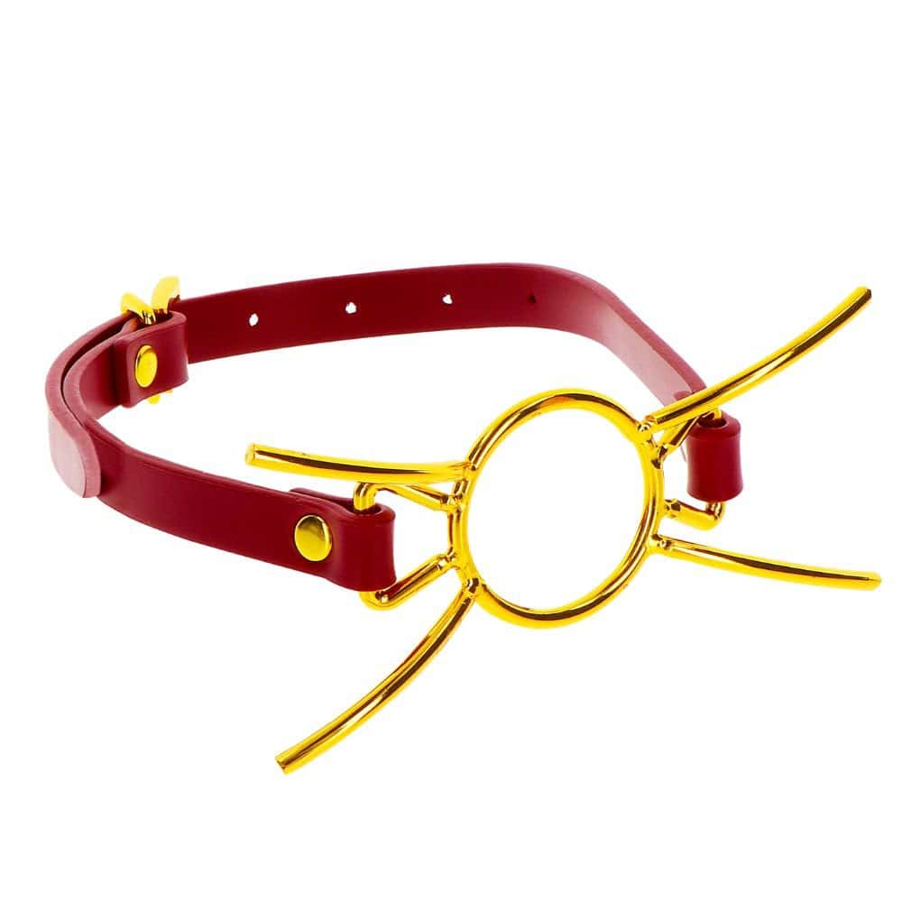 Packshot de 3/4 d'un Bâillon Bouche Ouverte en Cuir Synthétique Rouge et Métal Or