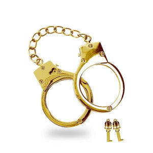 Menottes dorées en métal avec chaîne centrale et clés incluses, finition brillante, proposées par Brigade Mondaine Paris.