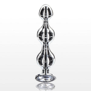 Plug anal en métal poli avec cristal facetté transparent, base évasée et finition brillante, présenté par Brigade Mondaine Paris.