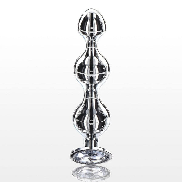 Plug anal en métal poli avec cristal facetté transparent, base évasée et finition brillante, présenté par Brigade Mondaine Paris.