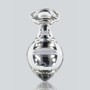 Plug anal en verre transparent poli à finition brillante, forme sphérique avec base évasée, présenté sur fond blanc, sélection Brigade Mondaine Paris.