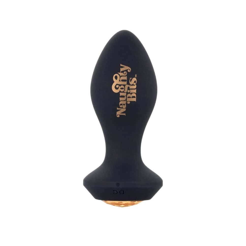 Plug anal noir en silicone avec base ornée d’un bijou facetté ambré, tenu en main, proposé par Brigade Mondaine Paris.