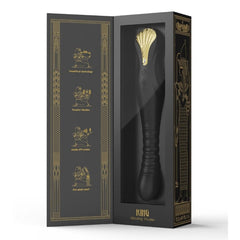 Stimulateur noir en silicone texturé avec finition dorée, présenté à la verticale sur fond sombre, proposé par Brigade Mondaine Sextoys Electriques Paris.