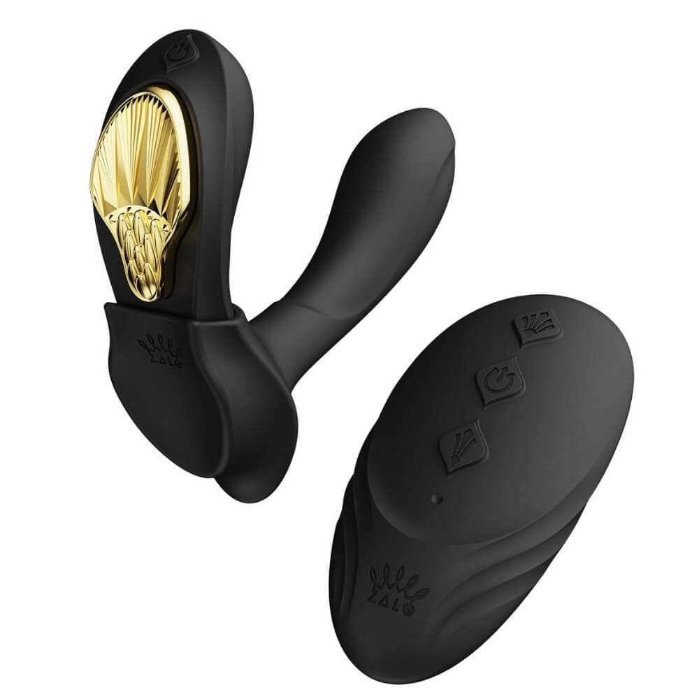 Vibromasseur portable de couleur noire avec détails dorés, design ergonomique et commandes intégrées, présenté sur fond blanc, sélection Brigade Mondaine Paris.