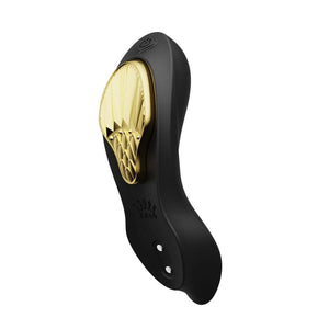 Vibromasseur portable de couleur noire avec détails dorés, design ergonomique et commandes intégrées, présenté sur fond blanc, sélection Brigade Mondaine Paris.