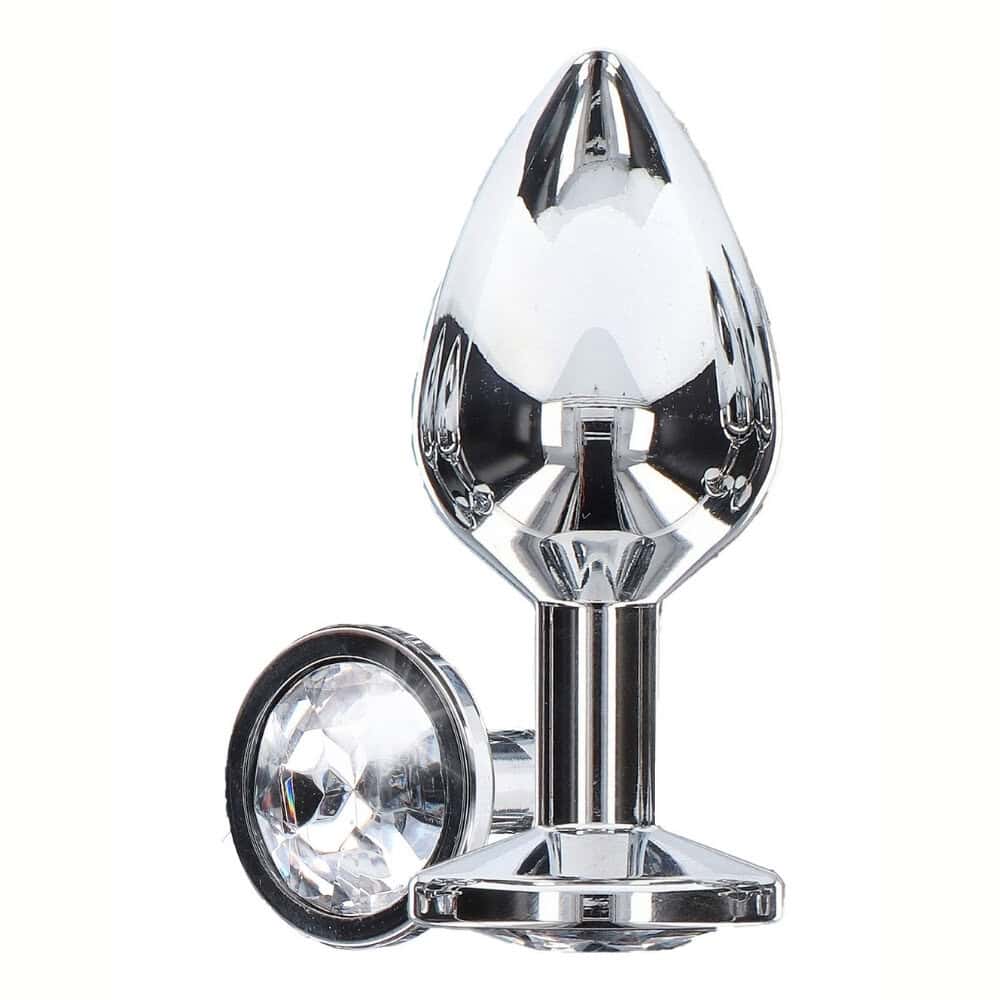 Plug anal en métal argenté poli effet miroir, à la forme lisse et effilée avec base plate assurant stabilité, présenté sur fond blanc dans une esthétique épurée.