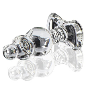 Plug anal en verre transparent à forme facettée avec base évasée, présenté sur fond clair, finition brillante, sélection Brigade Mondaine Paris.