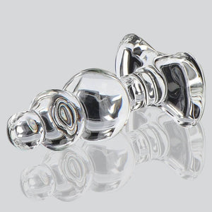 Plug anal en verre transparent à forme facettée avec base évasée, présenté sur fond clair, finition brillante, sélection Brigade Mondaine Paris.