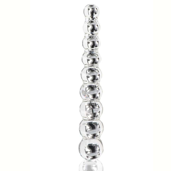 Dildo en verre transparent composé de formes sphériques alignées, présenté verticalement sur fond blanc, avec une finition lisse et brillante.