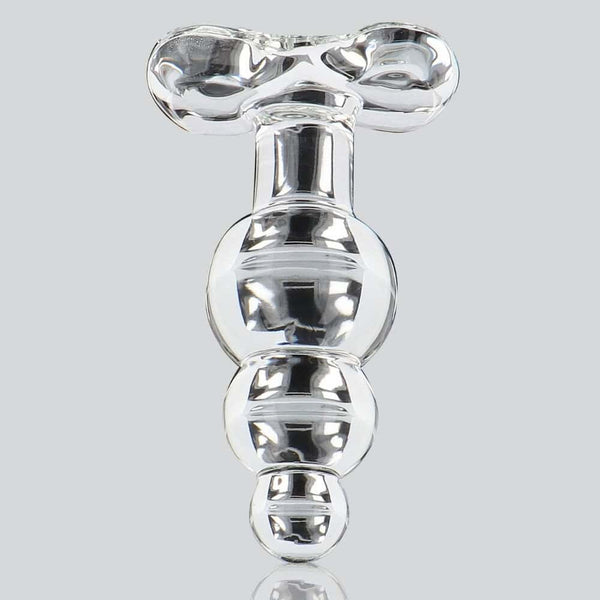 Plug anal en verre transparent à forme facettée avec base évasée, présenté sur fond clair, finition brillante, sélection Brigade Mondaine Paris.
