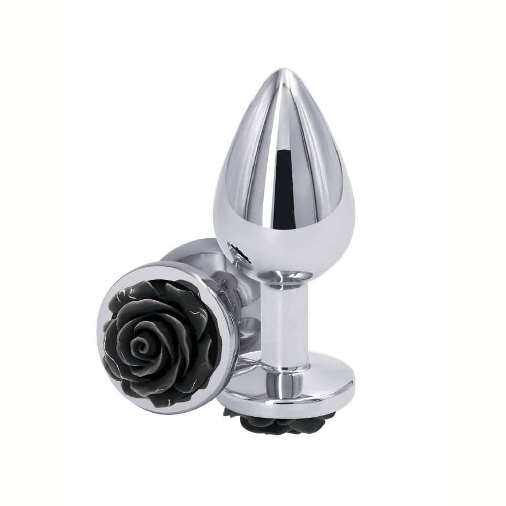 Plug anal en métal poli avec base décorative en forme de rose noire, posé sur fond blanc, sélection Brigade Mondaine Paris.