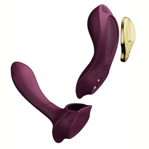 Vibromasseur portable de couleur prune avec détails dorés, design ergonomique et commandes intégrées, présenté sur fond blanc, sélection Brigade Mondaine Paris.