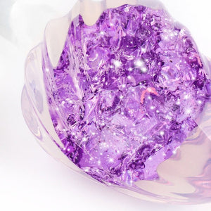 Plug en cristal translucide avec base évasée et texture interne brillante, accessoire proposé par Brigade Mondaine Paris.