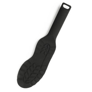 Paddle noire texturée avec poignée ergonomique et surface structurée, accessoire BDSM proposé par Brigade Mondaine Paris.
