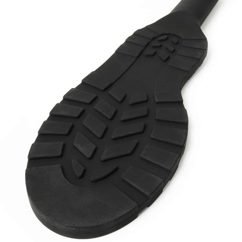 Paddle noire texturée avec poignée ergonomique et surface structurée, accessoire BDSM proposé par Brigade Mondaine Paris.