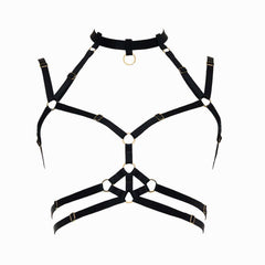 Harnais bondage Moon FLASH en sangles noires avec anneaux dorés, vue à plat sur fond blanc, design graphique et ajustable - Brigade Mondaine Paris