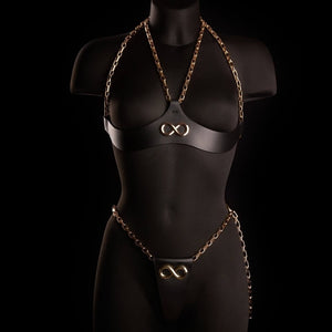 String ARIA IINFYNII en cuir noir avec chaînes dorées et symbole infini, pièce minimaliste et graphique, sélection Brigade Mondaine Paris