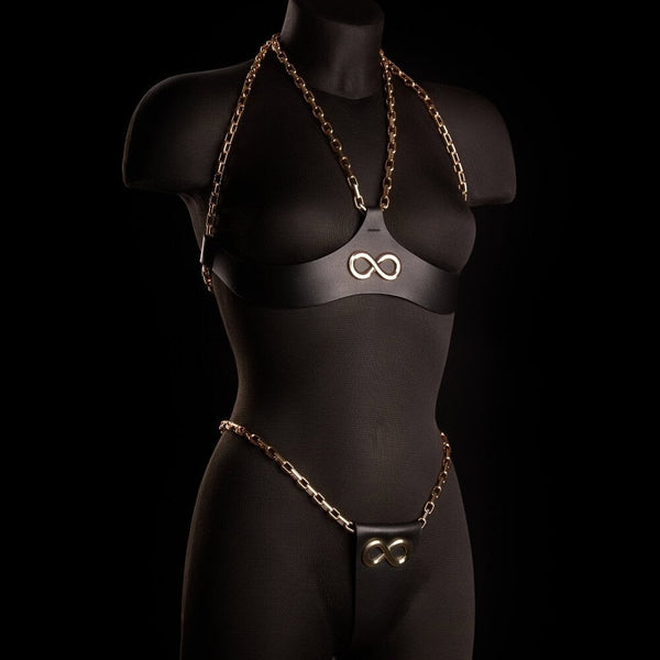 String ARIA IINFYNII en cuir noir avec chaînes dorées et symbole infini, pièce minimaliste et graphique, sélection Brigade Mondaine Paris