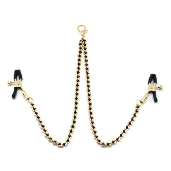 Chaîne avec pinces à tétons couleur or et perles noires, parfait pour le BDSM. Pinces réglables avec embouts en caoutchouc. Clip à dégagement rapide compatible avec différents colliers. Fabriqué en Chine.