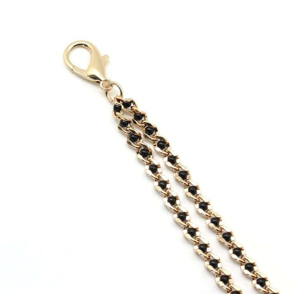 Chaîne avec pinces à tétons couleur or et perles noires, parfait pour le BDSM. Pinces réglables avec embouts en caoutchouc. Clip à dégagement rapide compatible avec différents colliers. Fabriqué en Chine.