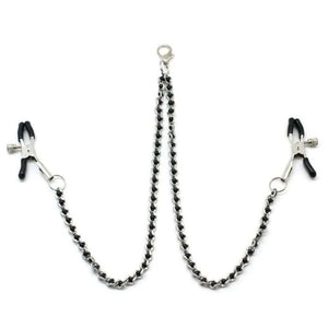 Chaîne avec pinces à tétons couleur argent et perles noires, idéal pour le BDSM. Pinces réglables avec embouts en caoutchouc. Clip à dégagement rapide compatible avec différents colliers. Fabriqué en Chine.