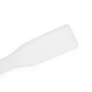 Paddle en cuir rose de la collection Fairy, confectionné en cuir d'agneau blanc et rose avec accents or rose. Un accessoire BDSM raffiné pour des jeux de fessée contrôlés et élégants.