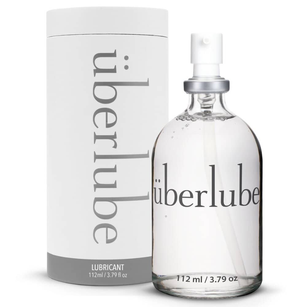 Flacon en verre de lubrifiant luxe transparent avec spray, présenté avec son étui cylindrique blanc, sélection Brigade Mondaine Paris.