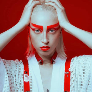 Modèle portant le Industrial Choker rouge Perlensau en cuir avec tiges métalliques et sphères argentées, proposé par Brigade Mondaine Paris.