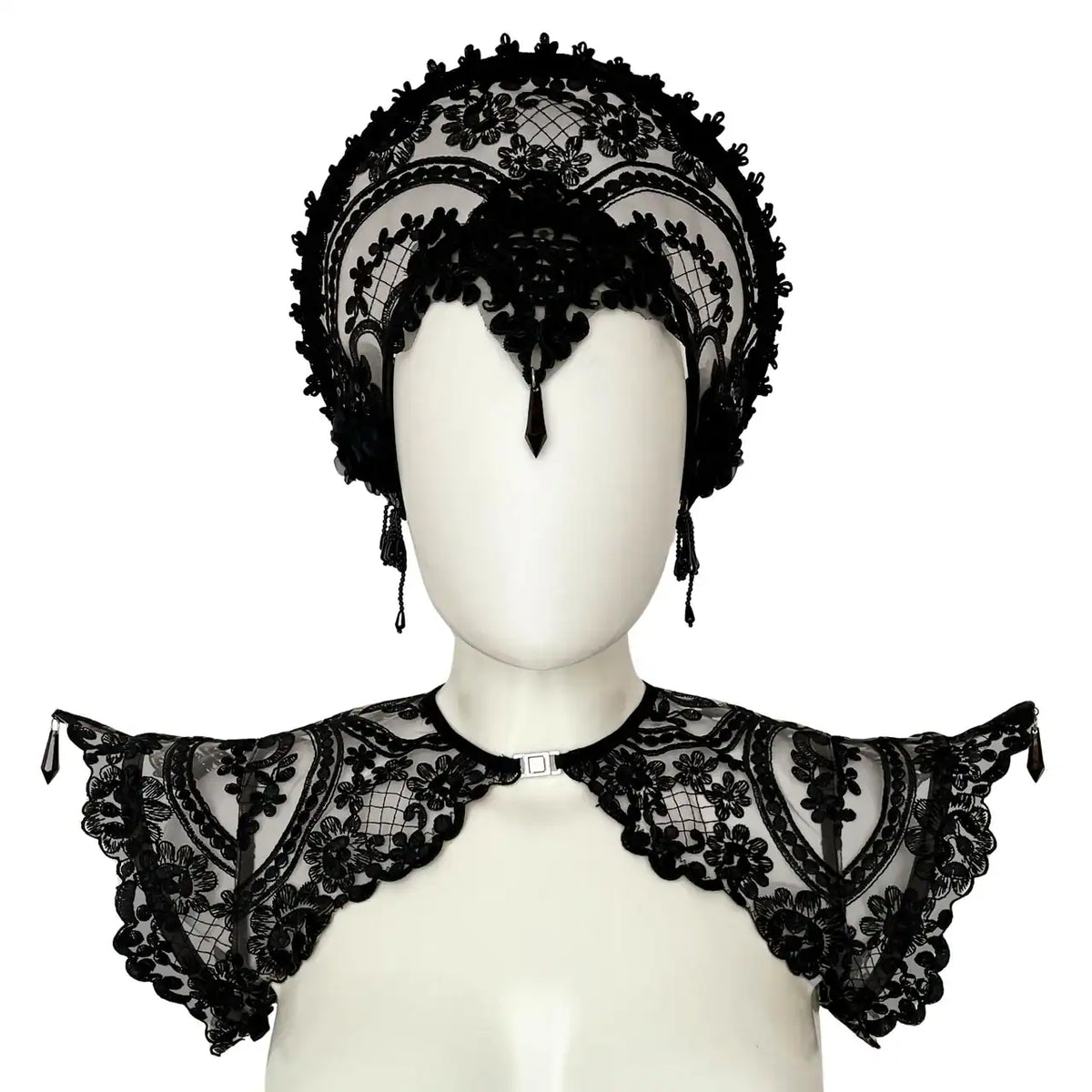 Handmade in Italy with custom floral embroidery on black mesh, this sculptural epaulette is reinforced with internal metal boning along the shoulder line to maintain its dramatic, elevated silhouette. Adjustable elastic bands positioned under the arms ensure comfort and stability while preserving structure. Front opening with metal clasp for a clean neckline and easy wear. Lightweight yet statement-making — a refined construction that balances delicacy and strength. Available in multiple sizes. Please refer