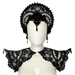 Handmade in Italy with custom floral embroidery on black mesh, this sculptural epaulette is reinforced with internal metal boning along the shoulder line to maintain its dramatic, elevated silhouette. Adjustable elastic bands positioned under the arms ensure comfort and stability while preserving structure. Front opening with metal clasp for a clean neckline and easy wear. Lightweight yet statement-making — a refined construction that balances delicacy and strength. Available in multiple sizes. Please refer