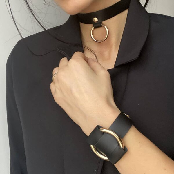 Choker and ANNA BRACELET both in black nappa leather with gold metal ring by MIA ATELIER at BRIGADE MONDAINE