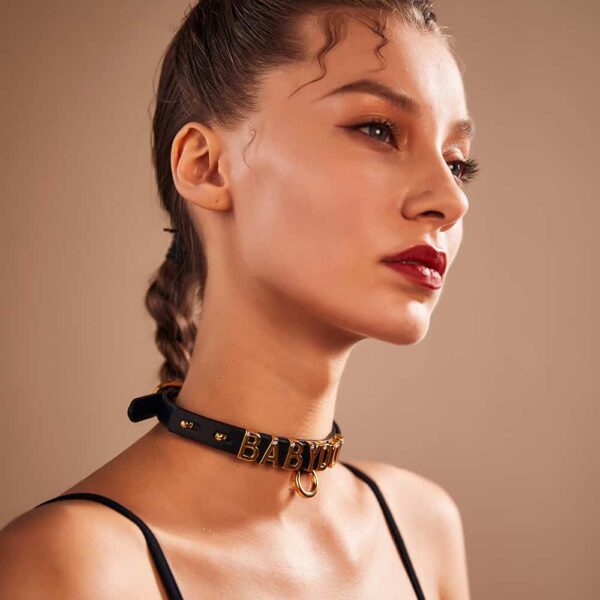 Choker resulting from the collaboration between Brigade Mondaine and Upko. The base of the choker is made from Italian leather and each letter is plated with 24 carat gold and encrusted with a crystal each.