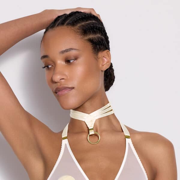 a black woman with a light-colored necklace