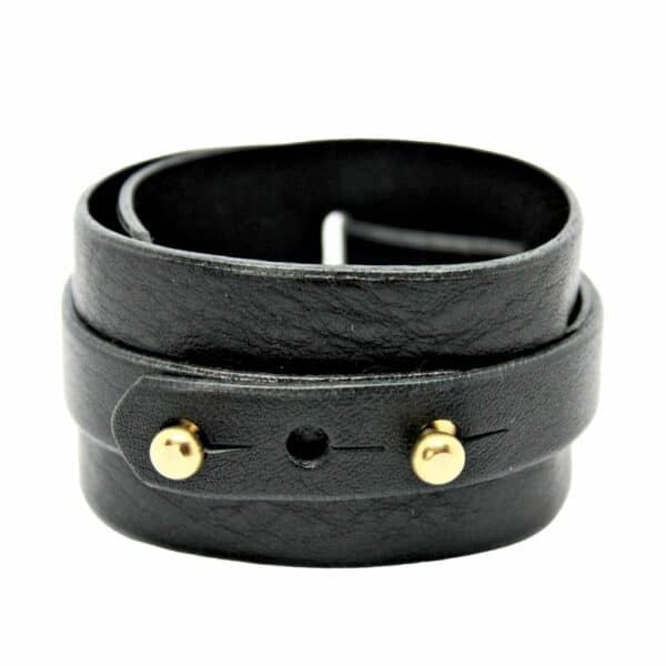 Packshot on white background of Una Burke's black leather wide D stacking cuff.