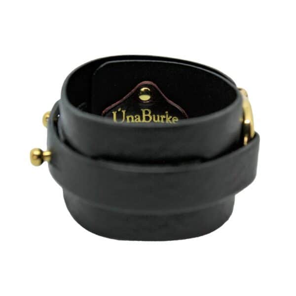 Packshot on white background of Una Burke's black leather wide D stacking cuff.