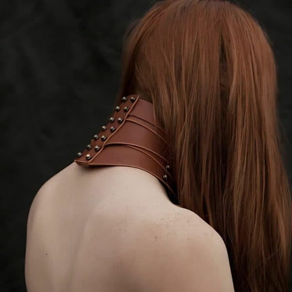 Woman from behind wearing a brown leather Una Burke necklace.